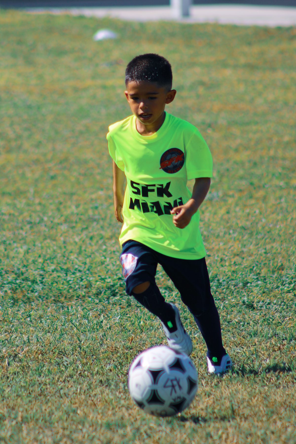 Young SFK player dribbling the ball during a development session